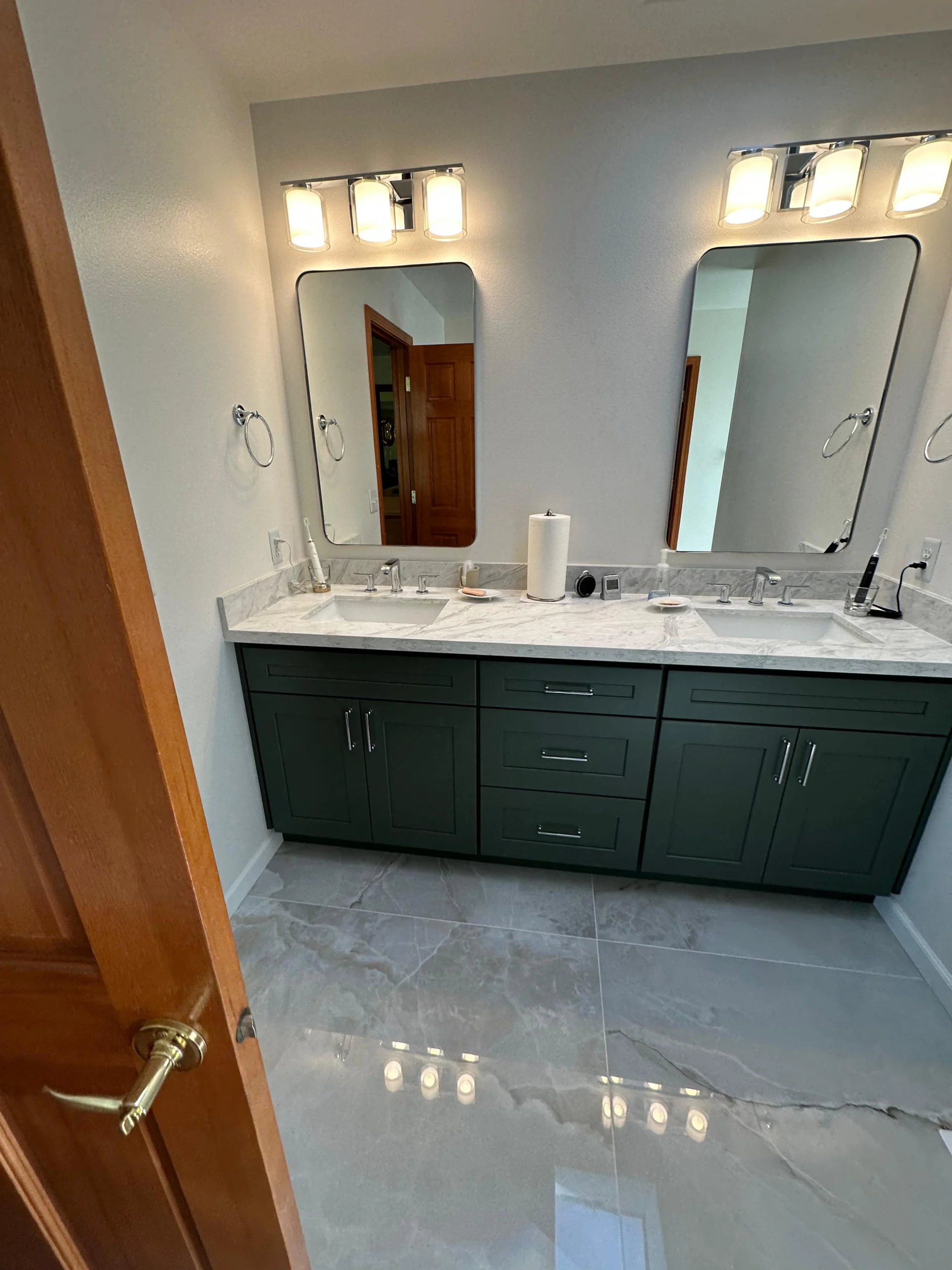 Dark green double vanity with marble top in a Complete Master Bathroom Remodel