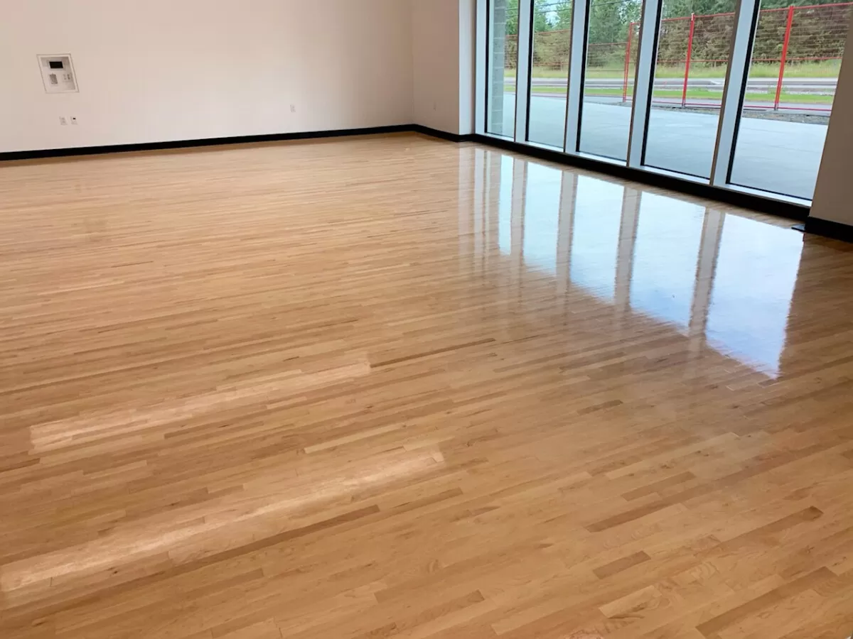 Flawless custom flooring installation showing thick-veneer engineered hardwood planks acclimating within a residential space.